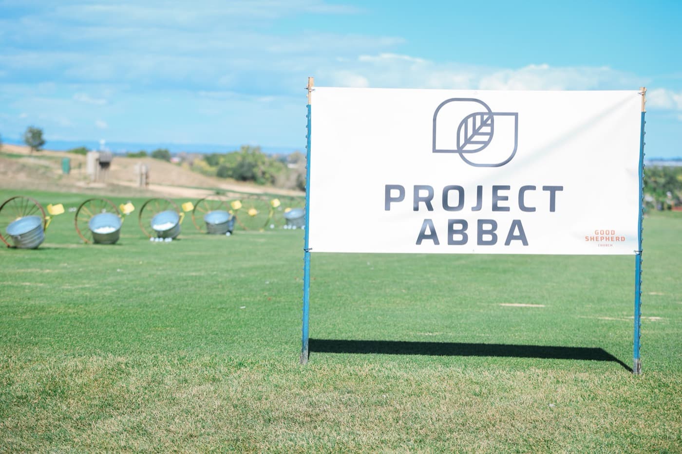 The Project Abba banner beside the driving range