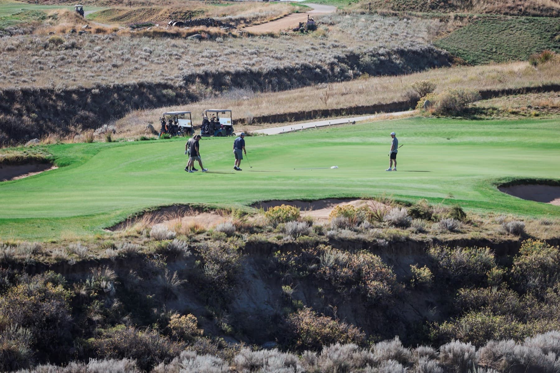 Players on a canyon-lined green at RainDance National during last year's tournament