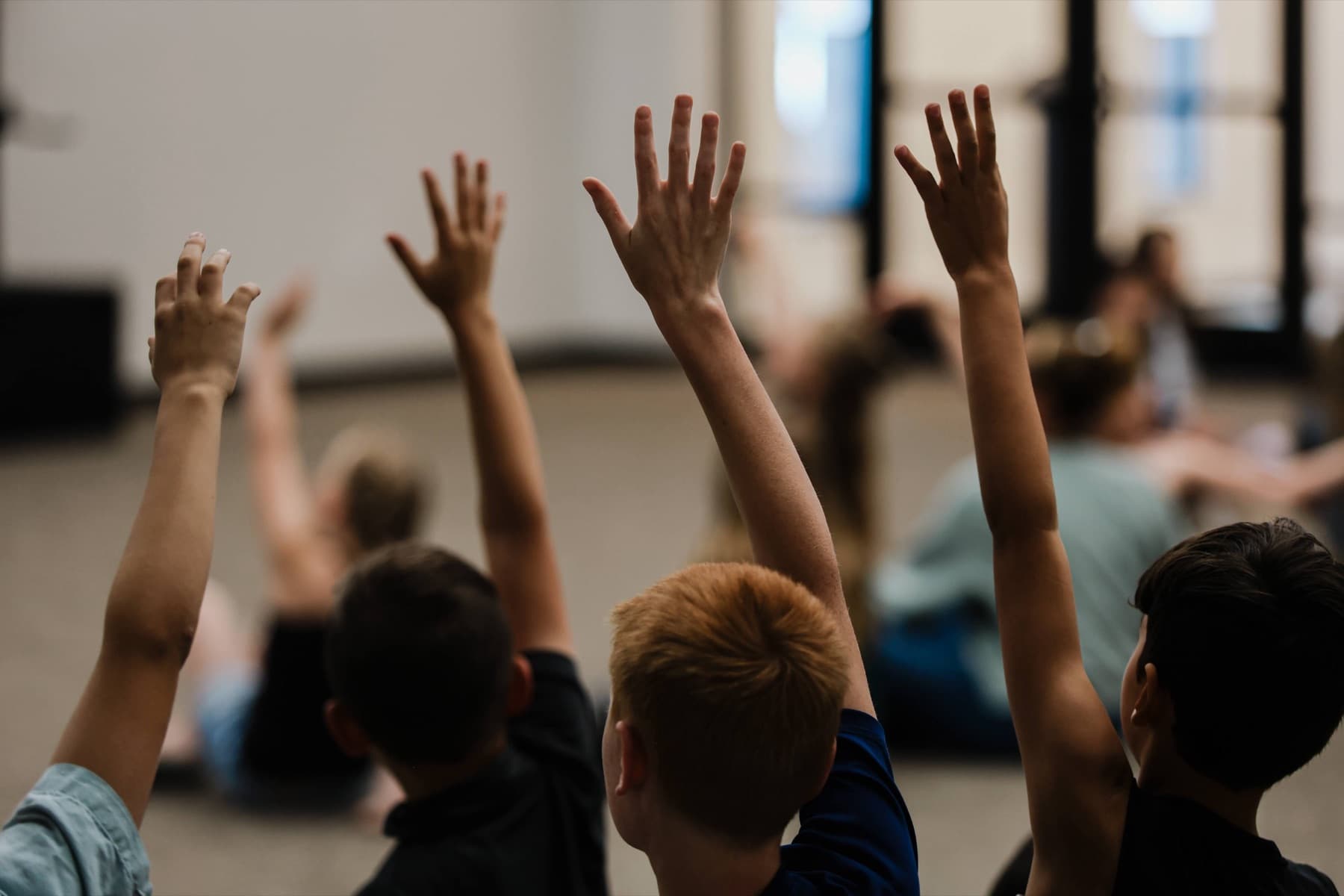 Kids at Good Shepherd Church raising their hands